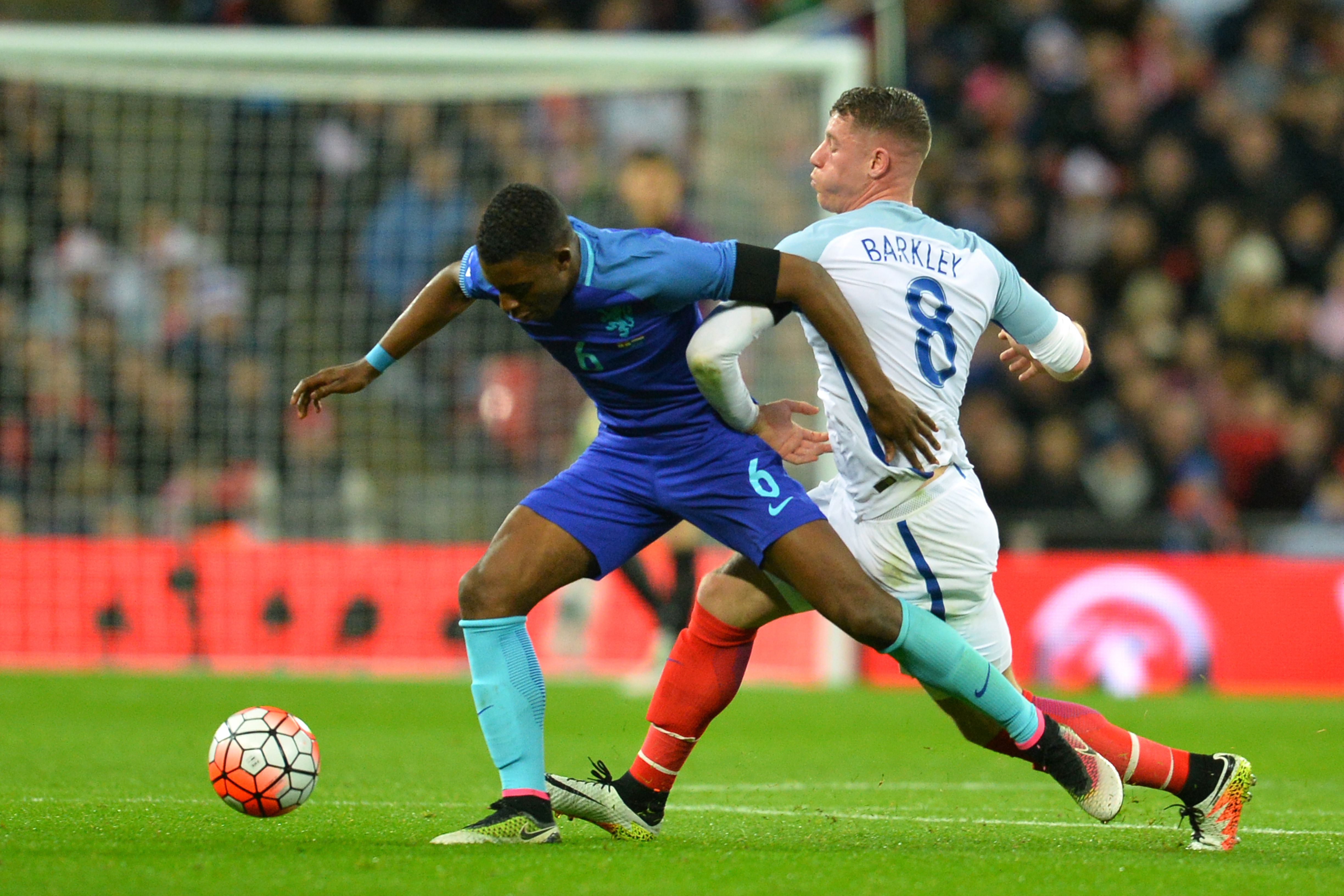 England's midfielder Ross Barkley (R) takes on Netherlands' midfielder Riechedly Bazoer (L) during the international friendly football match between England and Netherlands at Wembley Stadium in London on March 29, 2016. / AFP / GLYN KIRK / NOT FOR MARKETING OR ADVERTISING USE / RESTRICTED TO EDITORIAL USE (Photo credit should read GLYN KIRK/AFP/Getty Images)