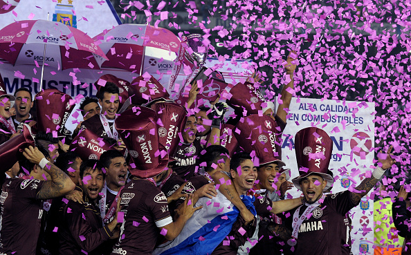 Lanus' footballers celebrate after winning the Argentina First Divison football tournament at the Momnumental stadium in Buenos Aires, Argentina, on May 29, 2016. Lanus won 4-0 to San Lorenzo and became champion. / AFP / ALEJANDRO PAGNI (Photo credit should read ALEJANDRO PAGNI/AFP/Getty Images)