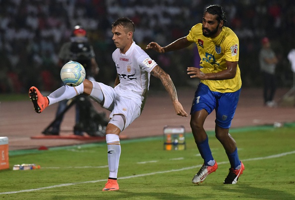 Northeast United FC's forward Nicolas Velez (L) tries to control the ball as Kerala Blasters FC's defender Sandesh Jhingan challenges during the Indian Super League (ISL) football match between Northeast United FC and Kerala Blasters FC at The Indira Gandhi Athletic Stadium in Guwahati on October 1, 2016. / AFP / Biju BORO 