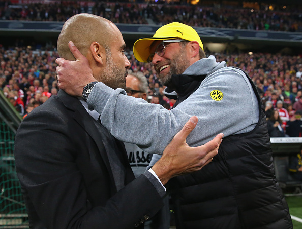 MUNICH, GERMANY - APRIL 28: Josep Guardiola, head coach of Bayern Muenche greets Juergen Klopp head coach of Dortmund at the start of the DFB Cup semi final match between FC Bayern Muenchen and Borussia Dortmund at Allianz Arena on April 28, 2015 in Munich, Germany. (Photo by Alexander Hassenstein/Bongarts/Getty Images)